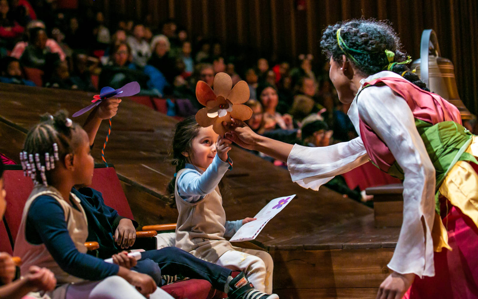 Janiah Lockett in Thumbelina with audience members.