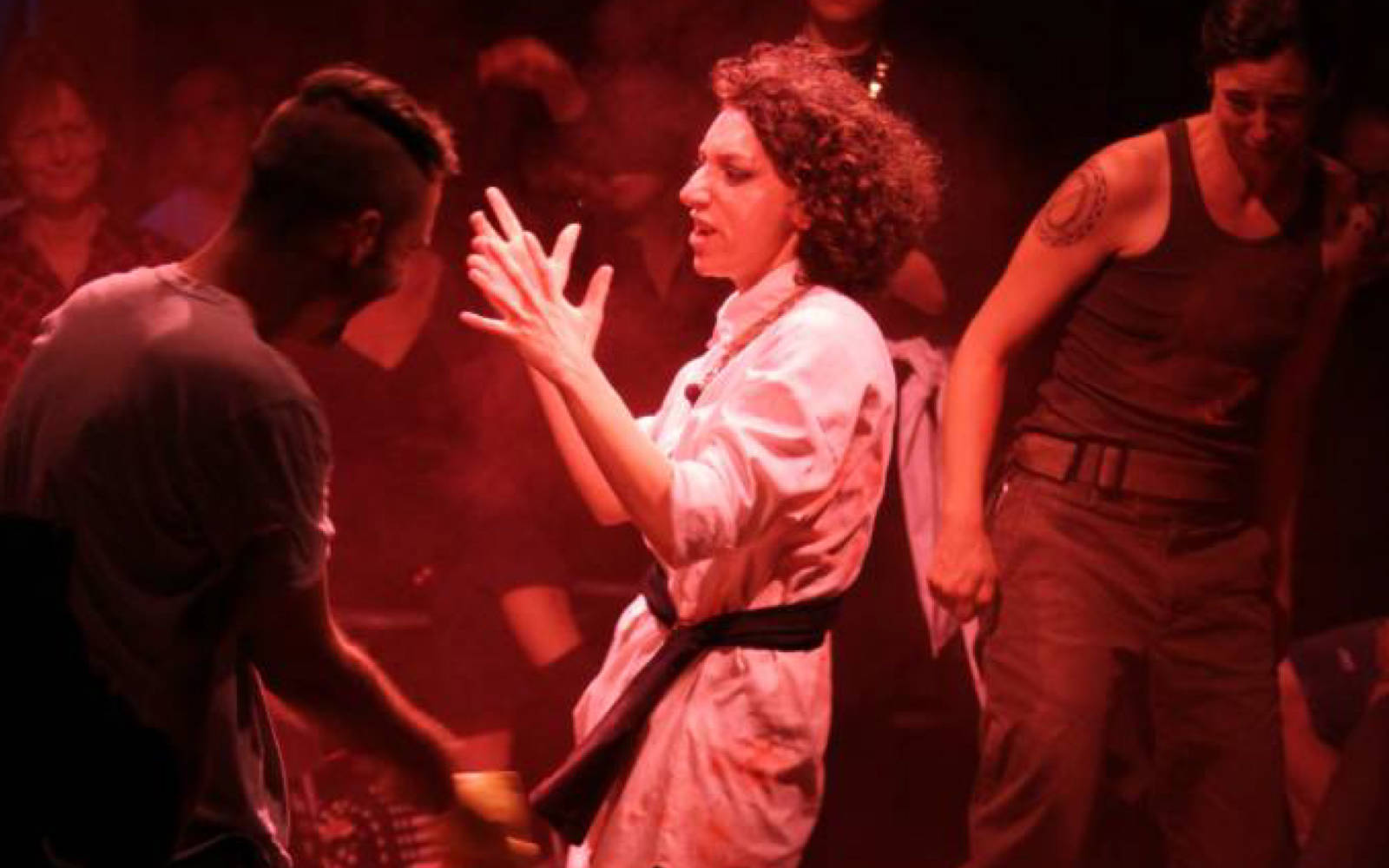 Rachel Mars being hit with rubber chickens by audience members.